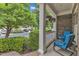 Cozy front porch with blue chairs, potted plants, and view of the neighborhood at 625 Canvas Dr, Wake Forest, NC 27587