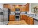 Well-equipped kitchen with stainless steel appliances and wooden cabinets at 625 Canvas Dr, Wake Forest, NC 27587