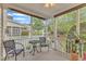 The screened porch offers ample seating and serene views, perfect for enjoying quiet moments outdoors at 625 Canvas Dr, Wake Forest, NC 27587