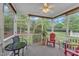 Relax on this screened porch, with a ceiling fan and a view of the lovely landscaping at 625 Canvas Dr, Wake Forest, NC 27587