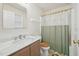 Bright bathroom featuring marble countertop vanity, toilet, and shower with decorative curtain at 6904 Fox Haven Pl, Raleigh, NC 27616