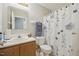 Well-maintained bathroom features a floral shower curtain and ample lighting at 6904 Fox Haven Pl, Raleigh, NC 27616