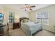Inviting bedroom with a large bed, window views, and classic furniture at 6904 Fox Haven Pl, Raleigh, NC 27616