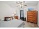 Comfortable bedroom featuring ceiling fan, dresser, and window with blinds at 6904 Fox Haven Pl, Raleigh, NC 27616