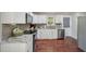 Bright kitchen features white cabinets, gray backsplash, granite countertops, and stainless steel appliances at 6904 Fox Haven Pl, Raleigh, NC 27616