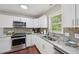 Lovely kitchen showcasing stainless steel appliances, white cabinetry, and granite countertops at 6904 Fox Haven Pl, Raleigh, NC 27616