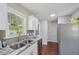 Modern kitchen with stainless steel refrigerator and countertops complemented by natural light at 6904 Fox Haven Pl, Raleigh, NC 27616