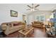 Cozy living room with vaulted ceilings, a ceiling fan, hardwood floors, and neutral-toned furniture at 6904 Fox Haven Pl, Raleigh, NC 27616