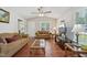 Bright living room with high ceilings, ceiling fan, two sofas, and hardwood floors at 6904 Fox Haven Pl, Raleigh, NC 27616