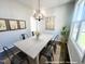 Dining room with modern chandelier, table, and ample natural light at 79 Butterbean Ct, Zebulon, NC 27597