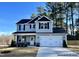 Two-story home with gray siding, black shutters, and a two-car garage at 79 Butterbean Ct, Zebulon, NC 27597