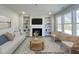 Cozy living room showcasing built-in shelving, a fireplace, and ample natural light at 79 Butterbean Ct, Zebulon, NC 27597