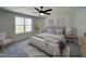Relaxing main bedroom featuring a large window and neutral decor at 79 Butterbean Ct, Zebulon, NC 27597