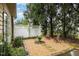 Landscaped backyard oasis with stone pathways, lush greenery, and a tranquil seating area at 8005 Crookneck Dr, Angier, NC 27501