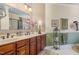 Bathroom with double vanity, large mirror, walk-in shower, and decorative accents at 8005 Crookneck Dr, Angier, NC 27501