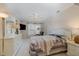 Bright bedroom with ceiling fan, dresser, and a large bed with neutral bedding at 8005 Crookneck Dr, Angier, NC 27501