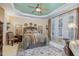 Spacious bedroom featuring a decorative ceiling, large windows, and a comfortable bed and linens at 8005 Crookneck Dr, Angier, NC 27501