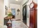 Inviting entryway features hardwood floors, a grandfather clock, decorative rug, and ample natural light at 8005 Crookneck Dr, Angier, NC 27501