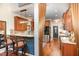 Open kitchen with stainless steel appliances, granite countertops, bar seating, and hardwood floors at 8005 Crookneck Dr, Angier, NC 27501