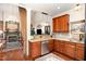 Kitchen with custom cabinets, granite countertops, stainless steel appliances, and hardwood floors at 8005 Crookneck Dr, Angier, NC 27501