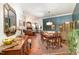 Spacious living and dining room with hardwood floors, elegant furnishings, and abundant natural light at 8005 Crookneck Dr, Angier, NC 27501