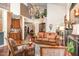 Open-concept living room with wood floors, fireplace, high ceilings, and views to the kitchen at 8005 Crookneck Dr, Angier, NC 27501