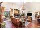 Bright living room featuring tall ceilings, hardwood floors, fireplace, and large windows for natural light at 8005 Crookneck Dr, Angier, NC 27501