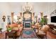 Elegant living room with hardwood floors, a fireplace, tall ceilings, and a chandelier at 8005 Crookneck Dr, Angier, NC 27501