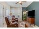 Cozy sitting room with leather recliners, lush plants, a dark accent wall, and plenty of natural light at 8005 Crookneck Dr, Angier, NC 27501