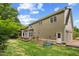 View of back of home from yard showing deck, door, and many windows for natural light at 809 Parkridge Dr, Clayton, NC 27527