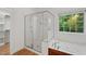 Bathroom features a separate shower and tub, plus a window offering natural light at 809 Parkridge Dr, Clayton, NC 27527