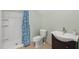 This bathroom features a tiled shower with blue patterned shower curtain, toilet, and modern vanity with sink at 809 Parkridge Dr, Clayton, NC 27527