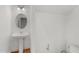 Bathroom featuring a pedestal sink, an oval mirror, and a white tiled wall at 809 Parkridge Dr, Clayton, NC 27527