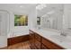 Bathroom featuring a jacuzzi tub, double sink vanity, and a large mirror at 809 Parkridge Dr, Clayton, NC 27527