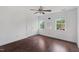 Bright bedroom with hardwood floors, two windows, and a ceiling fan at 809 Parkridge Dr, Clayton, NC 27527