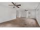 Large bedroom with carpet, two ceiling fans, and multiple windows at 809 Parkridge Dr, Clayton, NC 27527