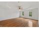 Spacious bedroom showcasing hardwood floors, tray ceiling, and natural light from two large windows at 809 Parkridge Dr, Clayton, NC 27527