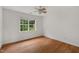 Bright bedroom featuring hardwood floors, ceiling fan, and a window with natural light at 809 Parkridge Dr, Clayton, NC 27527