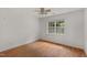 Cozy bedroom with hardwood floors, white walls, and a bright window at 809 Parkridge Dr, Clayton, NC 27527
