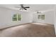 Spacious bedroom with carpet, two ceiling fans, and multiple windows at 809 Parkridge Dr, Clayton, NC 27527