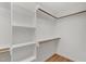 Bright walk-in closet with custom shelving and wooden racks for organized storage solutions at 809 Parkridge Dr, Clayton, NC 27527