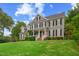 View of a two-story home with a manicured lawn, and a welcoming front porch at 809 Parkridge Dr, Clayton, NC 27527