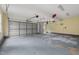 Spacious three car garage with painted floor, ample room for storage, and extra space for gym equipment at 809 Parkridge Dr, Clayton, NC 27527