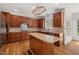Gourmet kitchen featuring wood cabinets, stainless steel appliances, and a large central island at 809 Parkridge Dr, Clayton, NC 27527