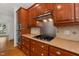Kitchen featuring wood cabinets, granite countertops, stainless steel appliances including gas range and microwave, with tile backsplash at 809 Parkridge Dr, Clayton, NC 27527