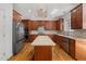 Gourmet kitchen featuring wood cabinets, stainless steel appliances, granite countertops, and a central island at 809 Parkridge Dr, Clayton, NC 27527