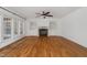 Bright living room featuring hardwood floors, a fireplace, and built-in shelving at 809 Parkridge Dr, Clayton, NC 27527