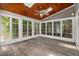 Bright sunroom with wood-paneled ceiling, skylights, and expansive windows offering natural light and views of the outdoors at 809 Parkridge Dr, Clayton, NC 27527