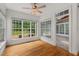 Bright sunroom with hardwood floors, large windows, and modern ceiling fan at 809 Parkridge Dr, Clayton, NC 27527