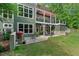 Spacious backyard featuring a patio, grill, outdoor seating and lush landscaping, perfect for outdoor relaxation at 8232 Glynmorgan Way, Chapel Hill, NC 27516